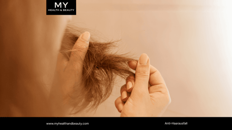 Person's hands gently hold a section of dry, damaged hair with visible split ends.
